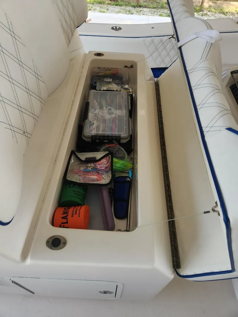 Slide: The Image of 2013 Invincible 36 Open Fisherman storage compartment with fishing gear and accessories. - 40