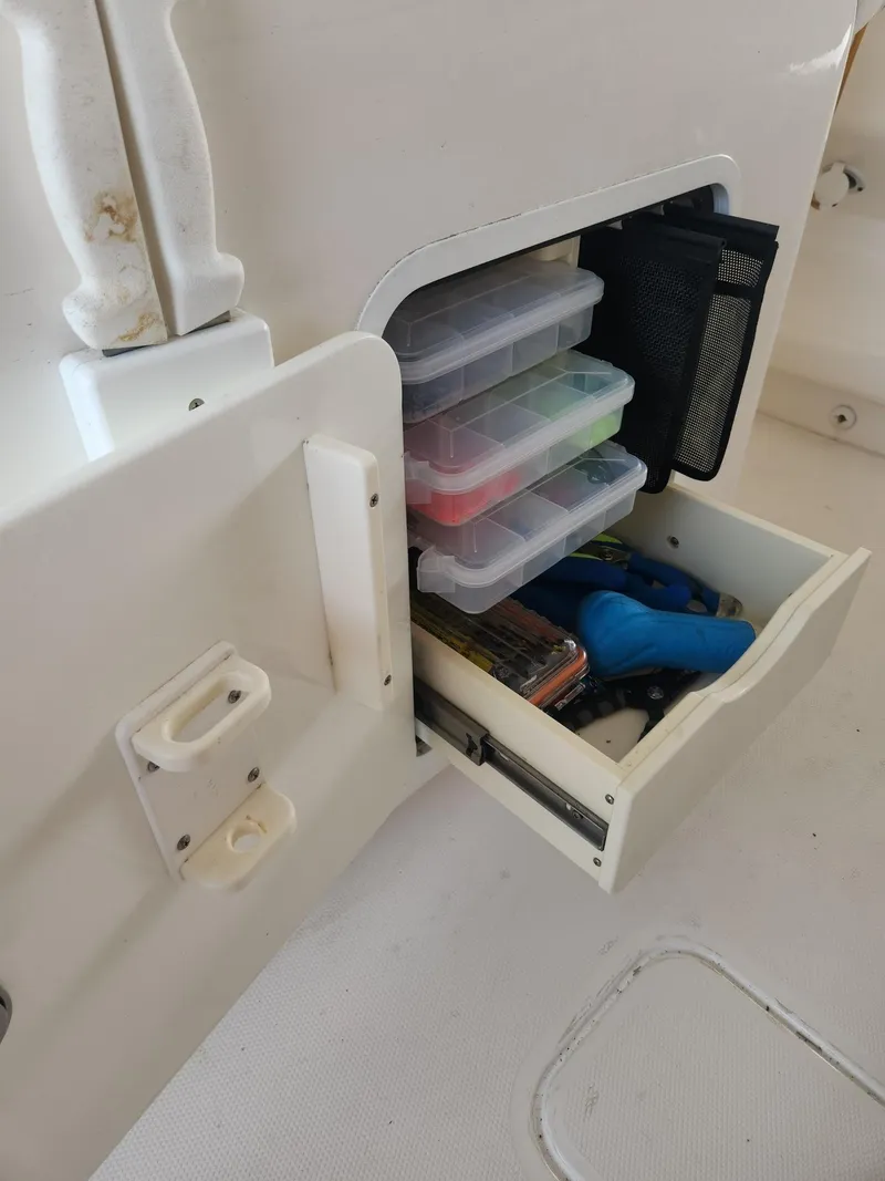 Slide: The Image of Storage compartment on 2013 Invincible 36 Open Fisherman with organized fishing gear and tackle boxes. - 41