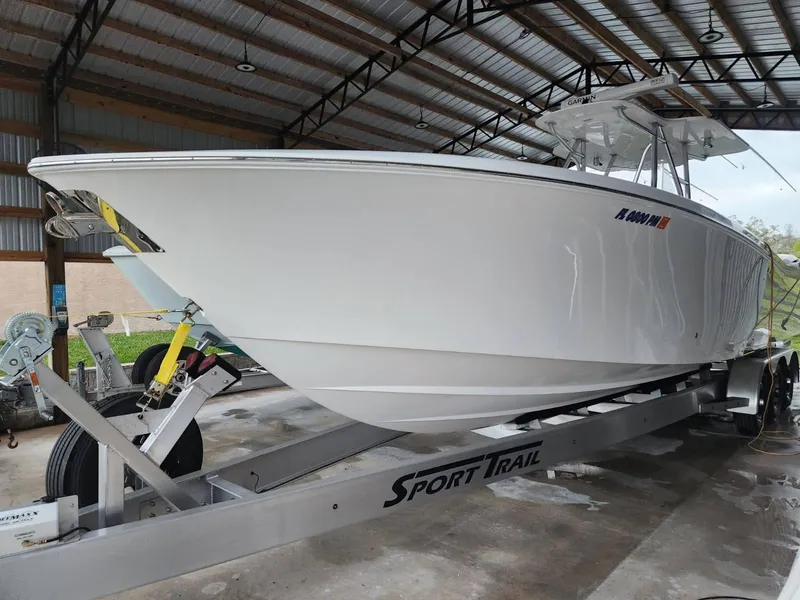 Slide: The Image of 2013 Invincible 36 Open Fisherman boat on Sport Trail trailer in covered storage. - 5
