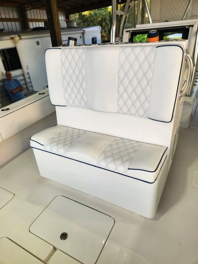 Slide: The Image of 2013 Invincible 36 Open Fisherman boat with white cushioned seating and diamond stitching. - 6