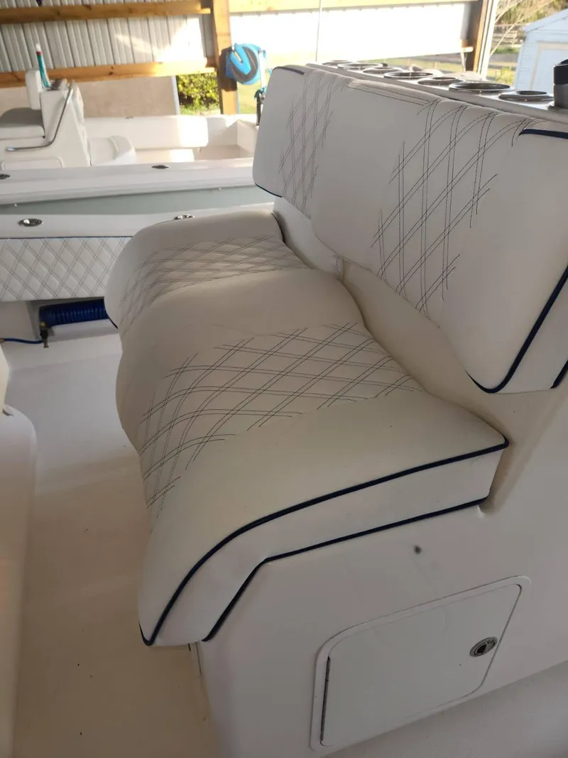 Slide: The Image of 2013 Invincible 36 Open Fisherman boat with white cushioned seating. - 7