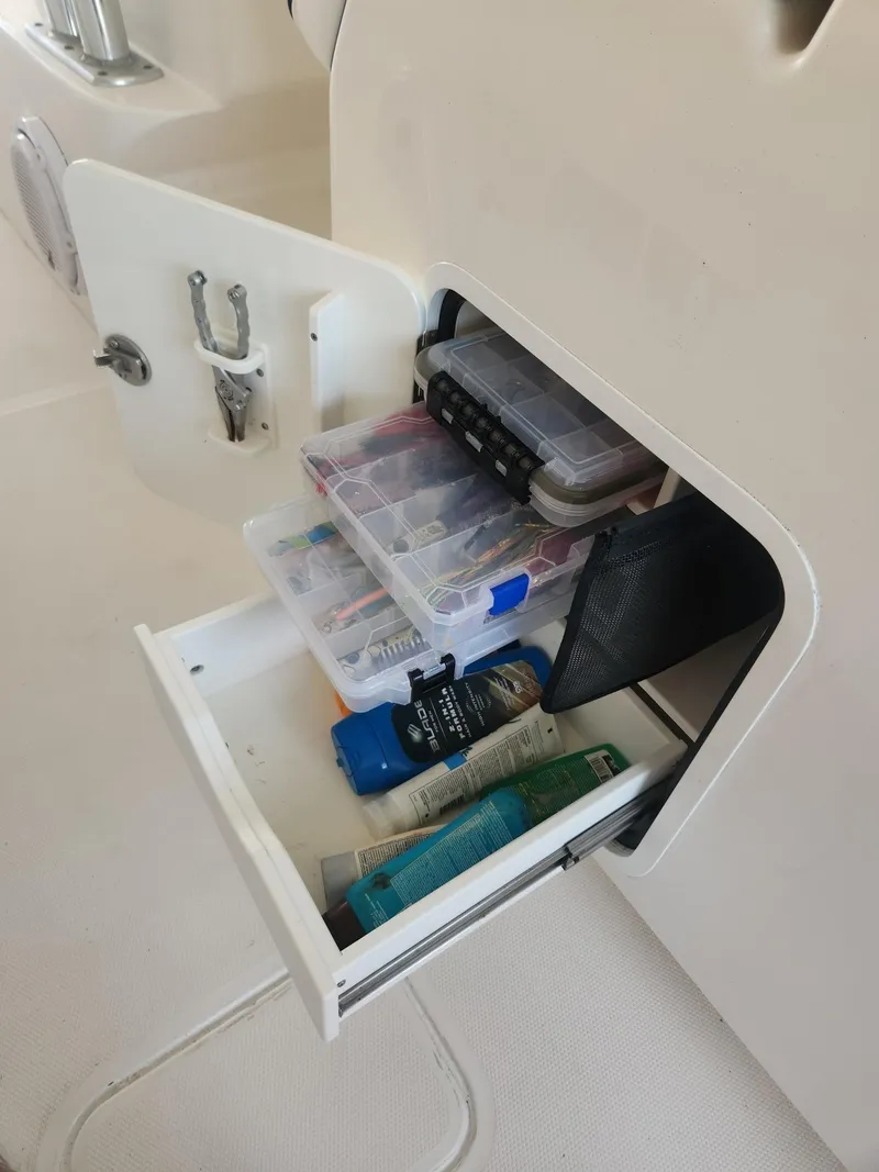 Slide: The Image of Storage compartment on a 2013 Invincible 36 Open Fisherman boat with organized supplies. - 9