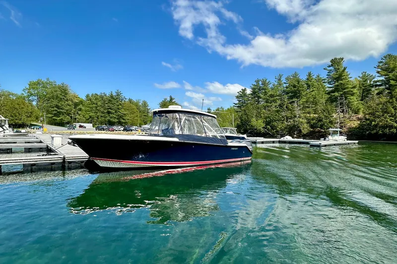 Slide: The Image of 2012 Pursuit S 280 Sport boat docked on a sunny day with clear blue skies. - 0