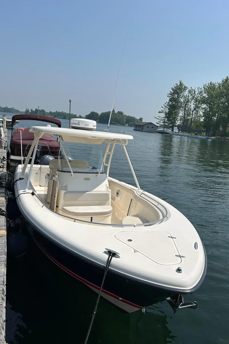 Slide: The Image of 2012 Pursuit S 280 Sport boat docked on a calm lake. - 13