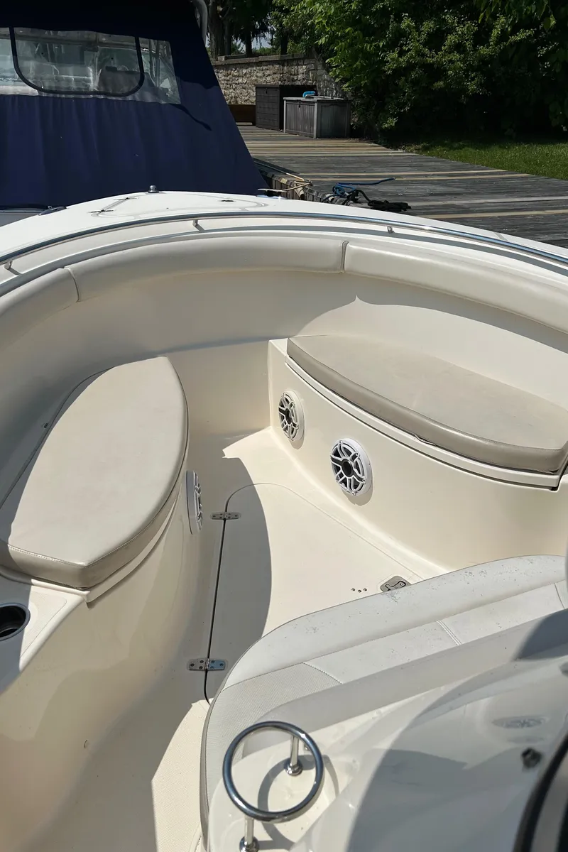 Slide: The Image of 2012 Pursuit S 280 Sport boat interior with cushioned seating and speakers. - 14