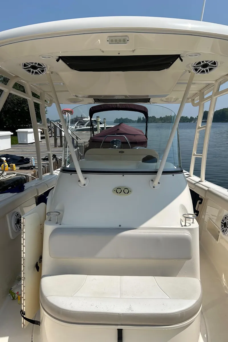 Slide: The Image of 2012 Pursuit S 280 Sport boat docked by a serene waterfront. - 15