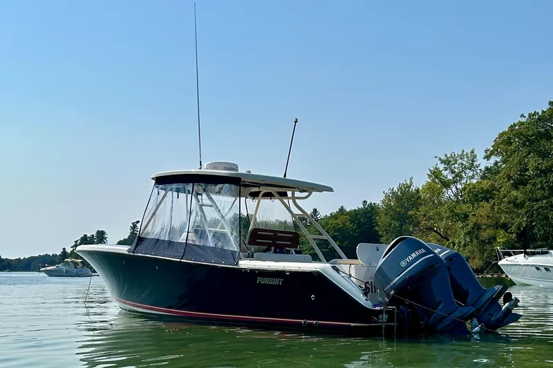 Slide: The Image of 2012 Pursuit S 280 Sport boat on calm water, featuring Yamaha outboard motor. - 4