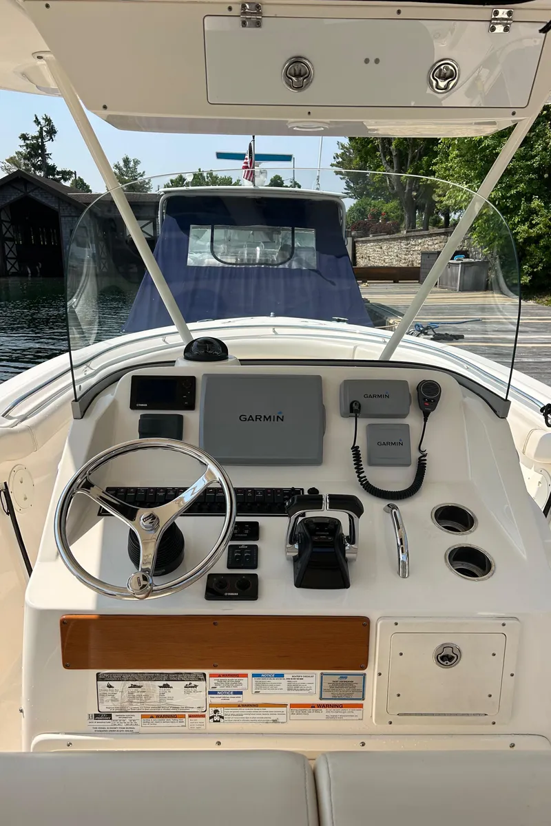 Slide: The Image of 2012 Pursuit S 280 Sport boat dashboard with steering wheel and navigation equipment. - 9