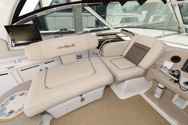Slide: The Image of Interior of 2006 Sea Ray 52 Sundancer yacht with beige seating and modern controls. - 10