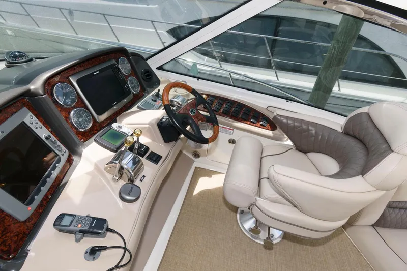 Slide: The Image of Helm of 2006 Sea Ray 52 Sundancer yacht with luxurious seating and advanced navigation controls. - 11
