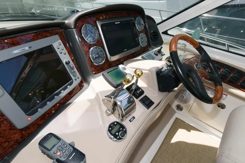 Slide: The Image of Helm of 2006 Sea Ray 52 Sundancer with advanced navigation controls and wood-accented steering wheel. - 12