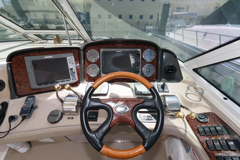 Slide: The Image of Helm of 2006 Sea Ray 52 Sundancer yacht with navigation instruments and wooden steering wheel. - 13