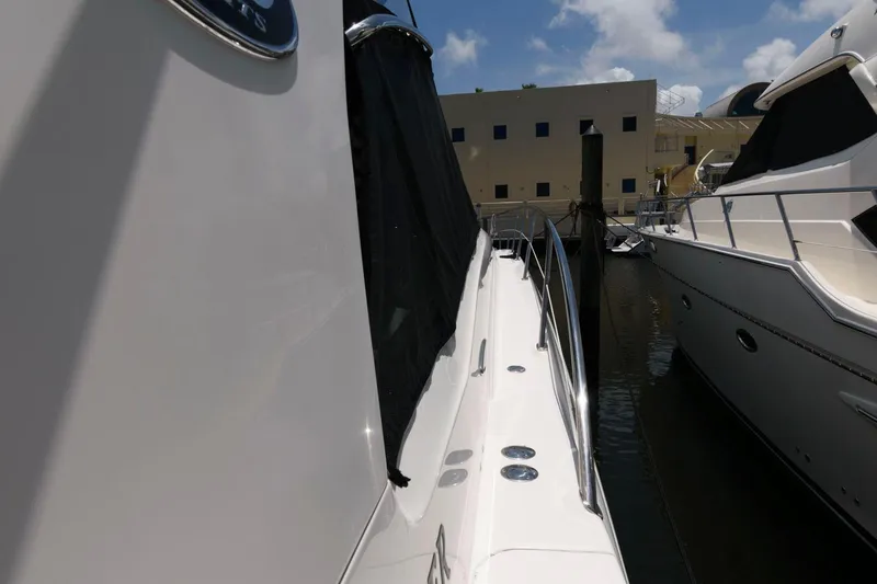 Slide: The Image of 2006 Sea Ray 52 Sundancer yacht docked beside another boat under a clear sky. - 20