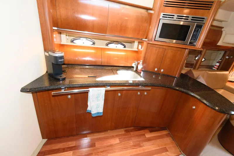 Slide: The Image of Luxurious kitchen area in a 2006 Sea Ray 52 Sundancer yacht with modern amenities. - 25
