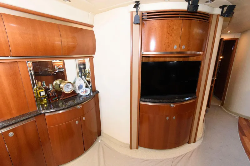 Slide: The Image of Luxurious interior of 2006 Sea Ray 52 Sundancer yacht with wooden cabinetry and entertainment center. - 26