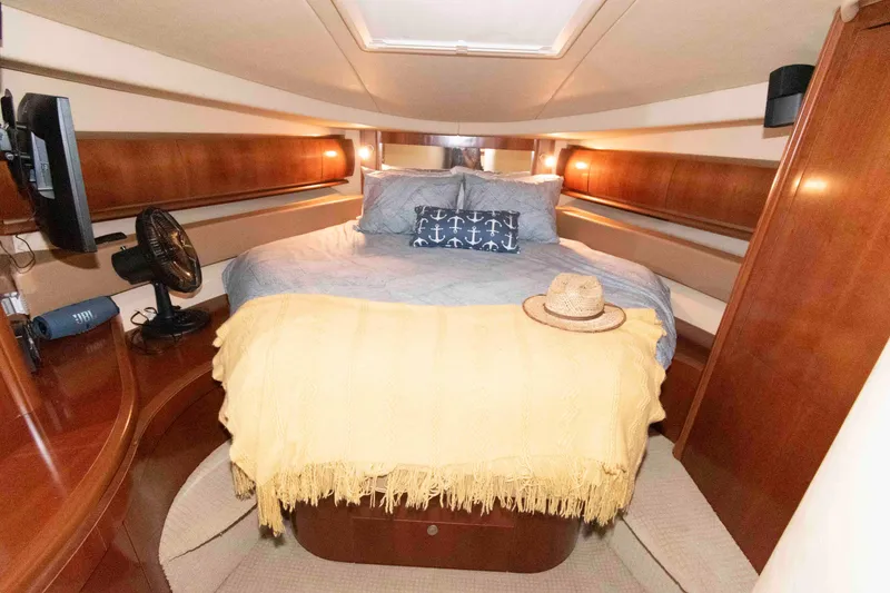 Slide: The Image of Luxurious 2006 Sea Ray 52 Sundancer cabin with cozy bed and elegant wood finishes. - 27