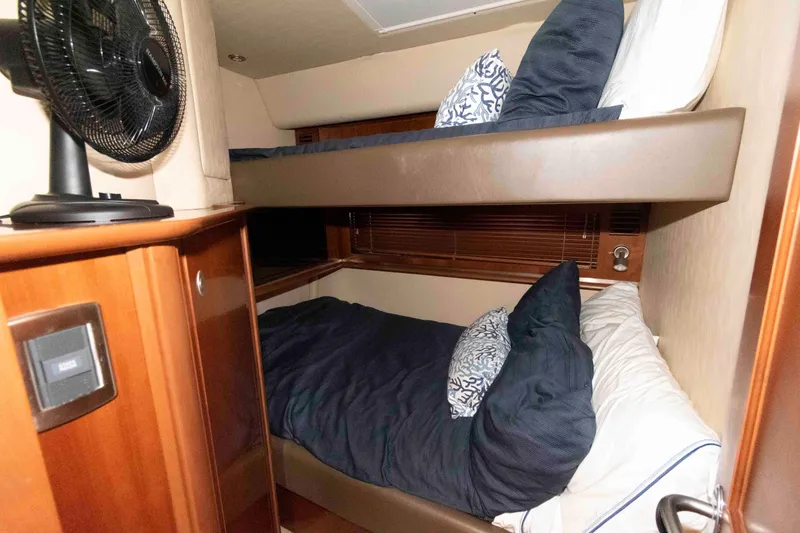 Slide: The Image of Bunk beds in 2006 Sea Ray 52 Sundancer yacht cabin with fan and wooden cabinetry. - 29