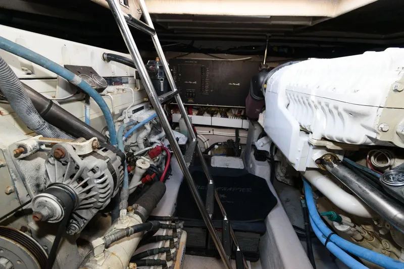 Slide: The Image of Engine room of a 2006 Sea Ray 52 Sundancer with visible machinery and ladder. - 32