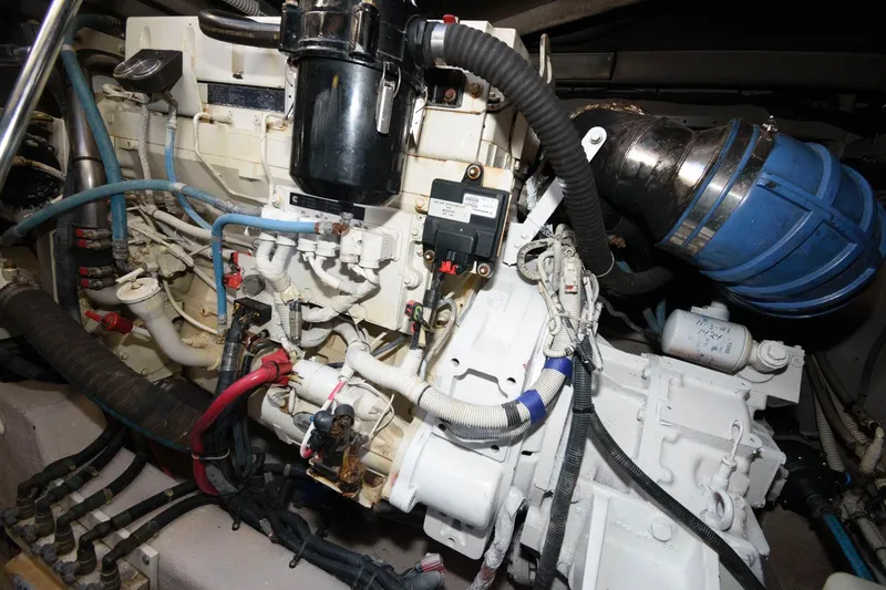 Slide: The Image of Engine compartment of a 2006 Sea Ray 52 Sundancer yacht, showcasing complex machinery and wiring. - 33