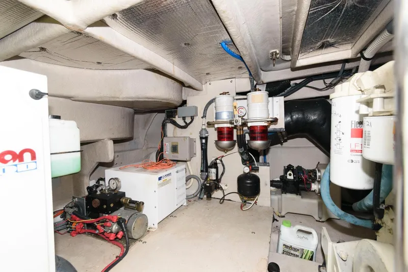 Slide: The Image of Engine room of a 2006 Sea Ray 52 Sundancer yacht, showcasing mechanical components and systems. - 36