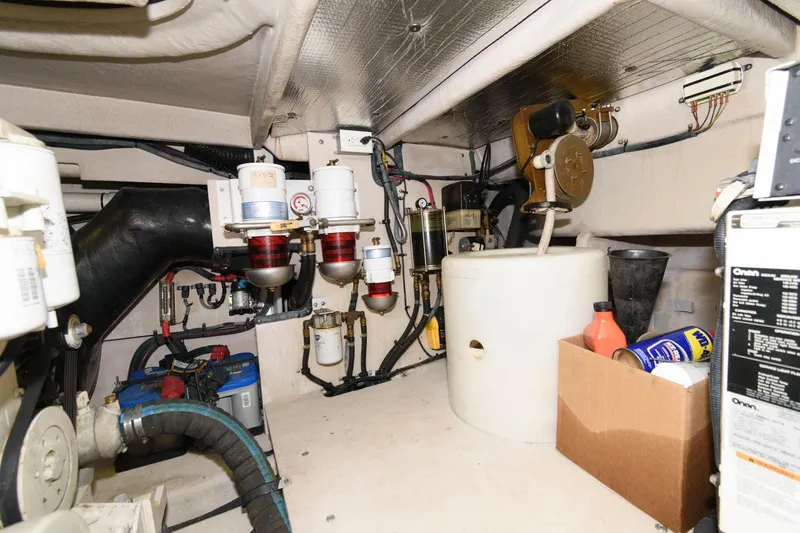Slide: The Image of Engine room of 2006 Sea Ray 52 Sundancer with various mechanical components and storage items. - 37