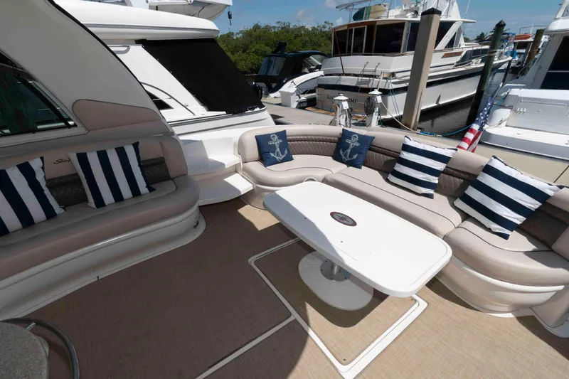 Slide: The Image of Luxurious 2006 Sea Ray 52 Sundancer yacht interior with elegant seating and nautical-themed cushions. - 9