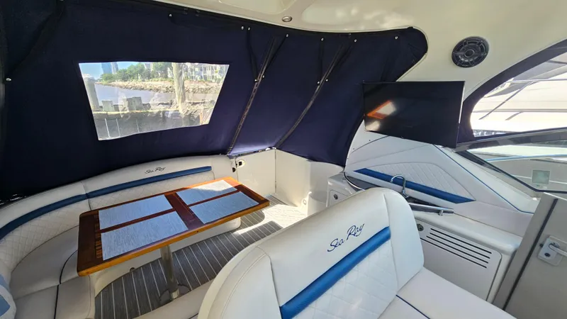 Slide: The Image of Interior of 2005 Sea Ray 390 Sundancer with seating, table, and TV. - 10