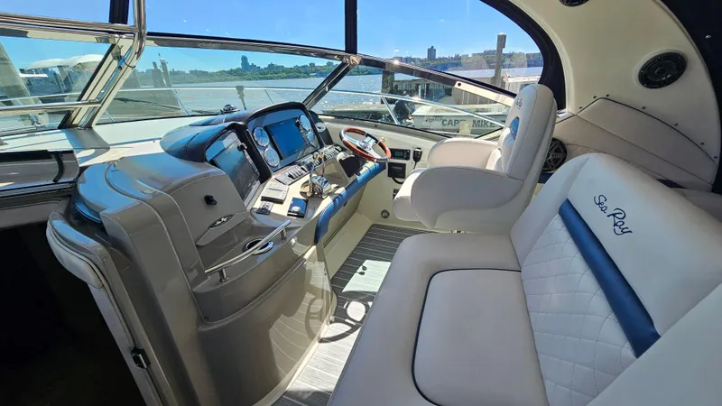 Slide: The Image of 2005 Sea Ray 390 Sundancer cockpit with luxurious seating and modern navigation controls. - 14