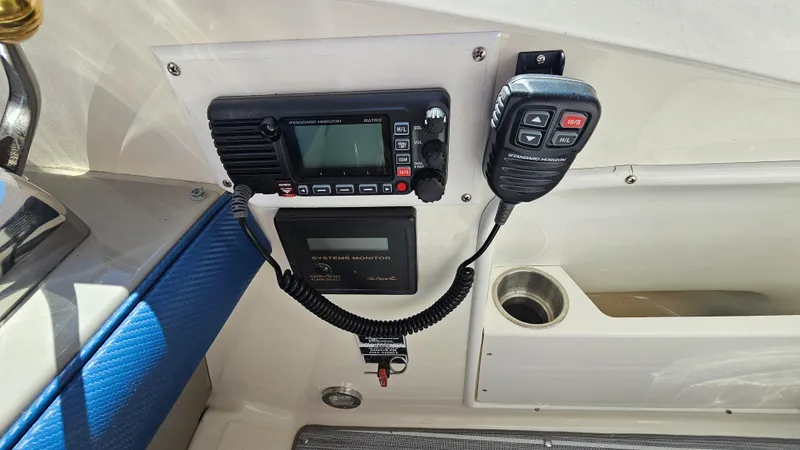Slide: The Image of Control panel of a 2005 Sea Ray 390 Sundancer with radio and microphone. - 18