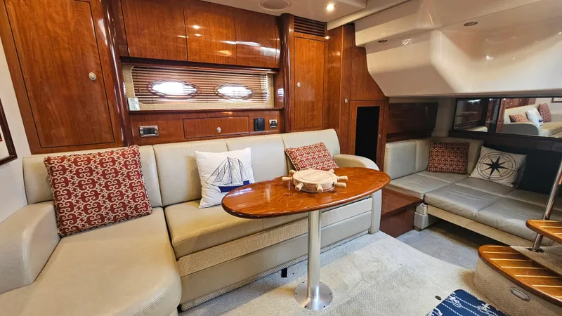 Slide: The Image of Luxurious 2005 Sea Ray 390 Sundancer interior with elegant seating and wooden accents. - 22
