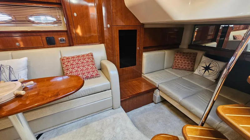 Slide: The Image of Interior of 2005 Sea Ray 390 Sundancer with beige seating and wooden accents. - 23
