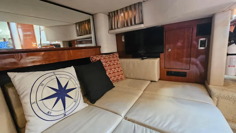 Slide: The Image of Interior of 2005 Sea Ray 390 Sundancer with cozy seating and decorative pillows. - 24