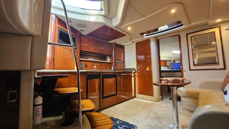 Slide: The Image of Luxurious interior of a 2005 Sea Ray 390 Sundancer yacht with wood cabinetry and seating. - 25