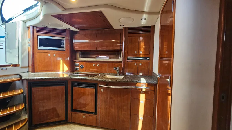 Slide: The Image of Luxurious 2005 Sea Ray 390 Sundancer yacht interior with modern kitchen amenities. - 26