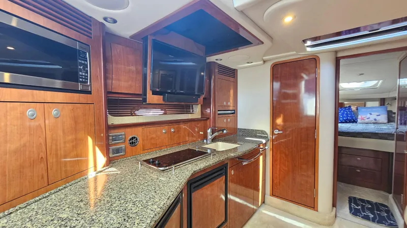 Slide: The Image of Luxurious 2005 Sea Ray 390 Sundancer yacht interior with modern kitchen amenities. - 28