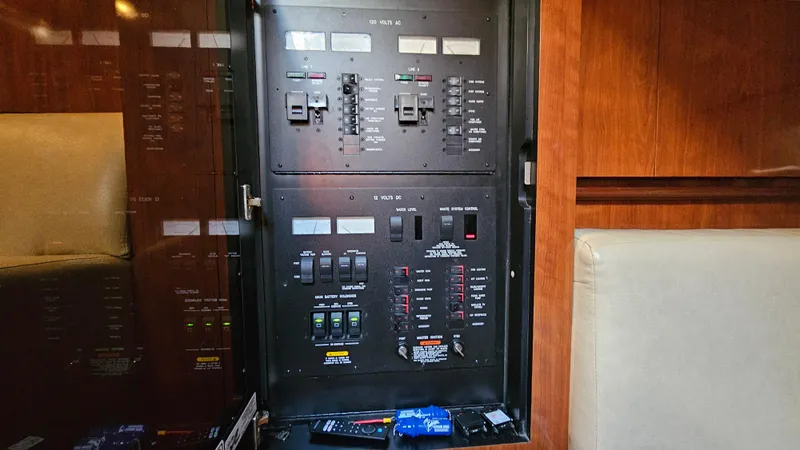 Slide: The Image of Electrical panel inside a 2005 Sea Ray 390 Sundancer yacht, featuring various switches and controls. - 29