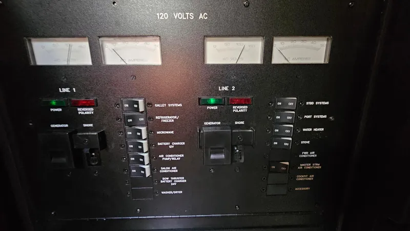 Slide: The Image of Electrical control panel of a 2005 Sea Ray 390 Sundancer boat, showing 120 volts AC meters. - 30