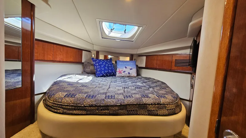 Slide: The Image of Luxurious cabin interior of 2005 Sea Ray 390 Sundancer yacht with skylight and cozy bedding. - 32