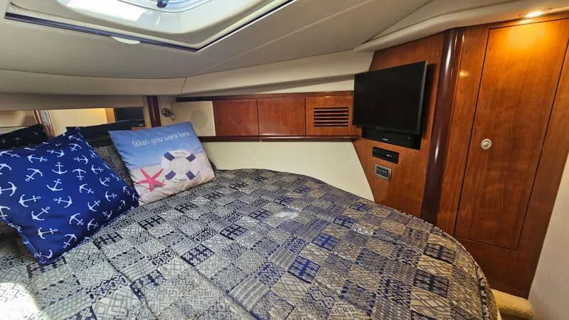 Slide: The Image of Luxurious cabin interior of 2005 Sea Ray 390 Sundancer with cozy bedding and TV. - 34
