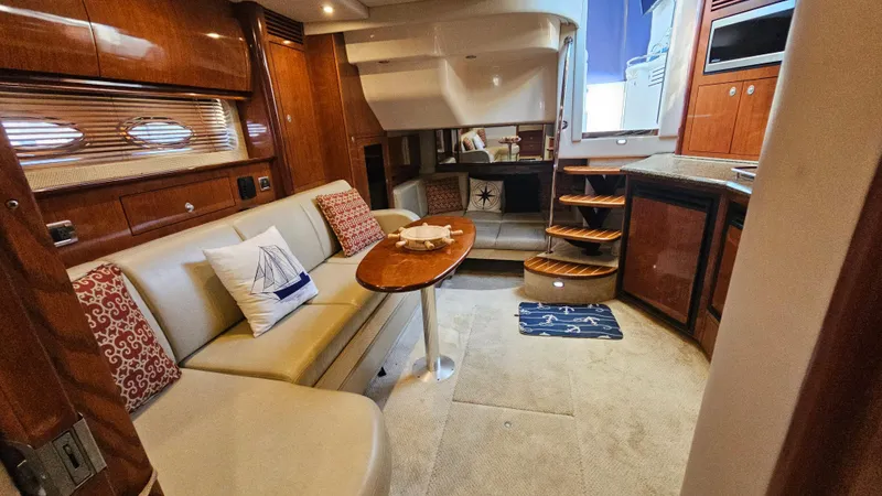 Slide: The Image of Luxurious interior of 2005 Sea Ray 390 Sundancer yacht with elegant seating and wooden finishes. - 38