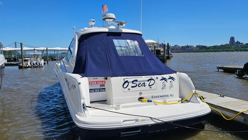 Slide: The Image of 2005 Sea Ray 390 Sundancer yacht docked, featuring a blue canopy and "For Sale" sign. - 4