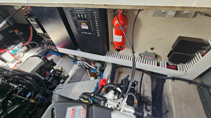 Slide: The Image of Engine room of a 2005 Sea Ray 390 Sundancer with visible wiring and fire extinguisher. - 42
