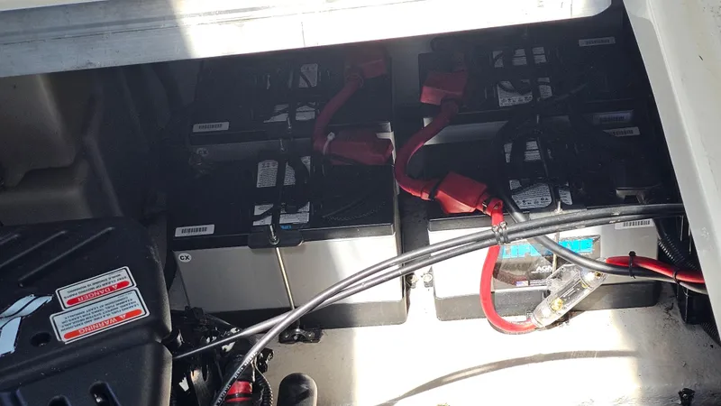 Slide: The Image of Battery compartment of a 2005 Sea Ray 390 Sundancer boat, showing multiple batteries and cables. - 43