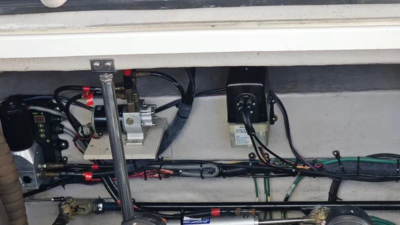 Slide: The Image of Engine compartment of a 2005 Sea Ray 390 Sundancer with visible wiring and components. - 44