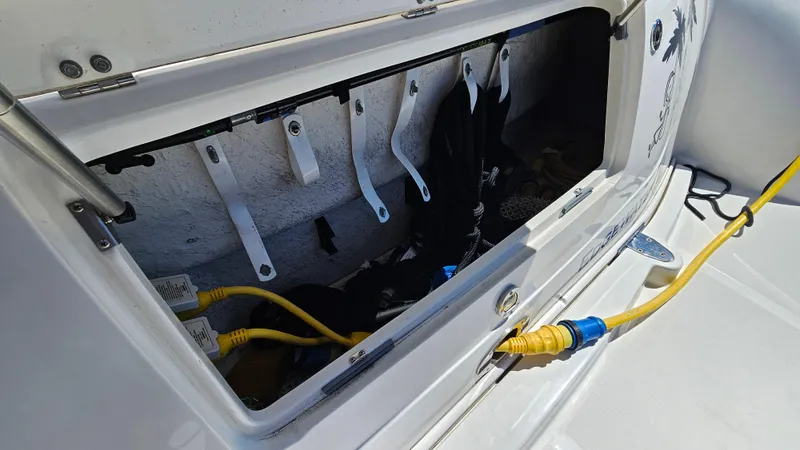 Slide: The Image of Open storage compartment on 2005 Sea Ray 390 Sundancer boat with yellow power cables. - 45