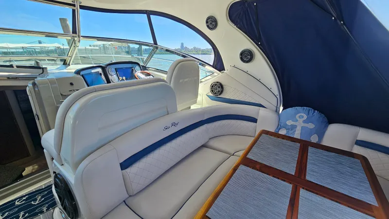 Slide: The Image of 2005 Sea Ray 390 Sundancer interior with white seating and wooden table. - 7