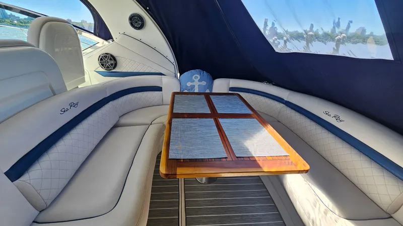 Slide: The Image of Luxurious interior of 2005 Sea Ray 390 Sundancer yacht with elegant seating and table. - 8