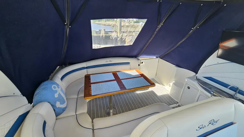 Slide: The Image of Interior of 2005 Sea Ray 390 Sundancer with blue canopy and seating area. - 9