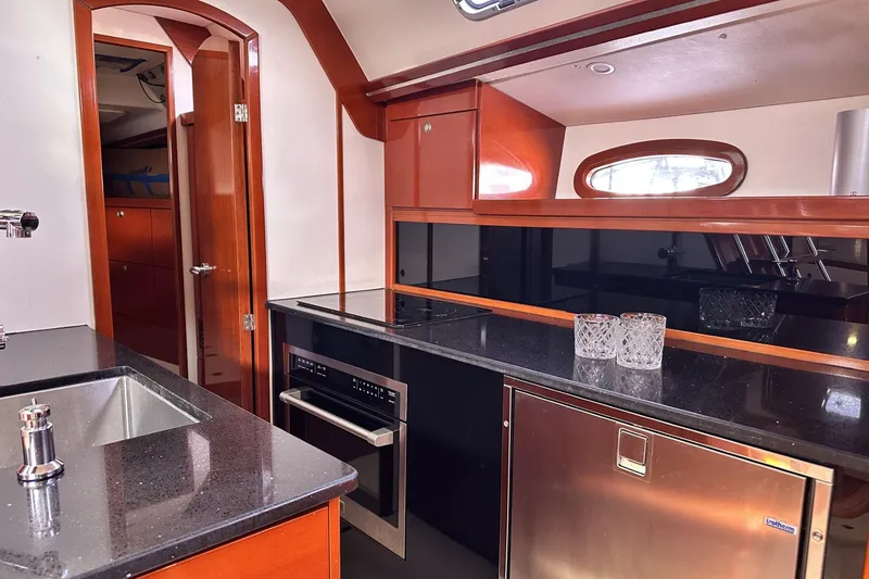 Slide: The Image of Luxurious 2006 Hanse 461 yacht kitchen with modern appliances and sleek design. - 14