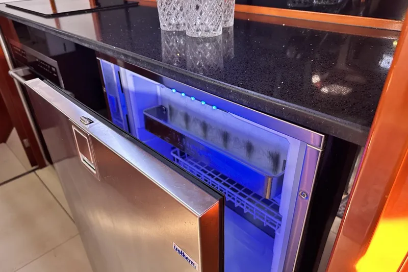 Slide: The Image of Open stainless steel fridge in 2006 Hanse 461 yacht kitchen with blue interior lighting. - 17